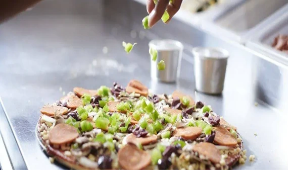 Fresh pizza being prepared